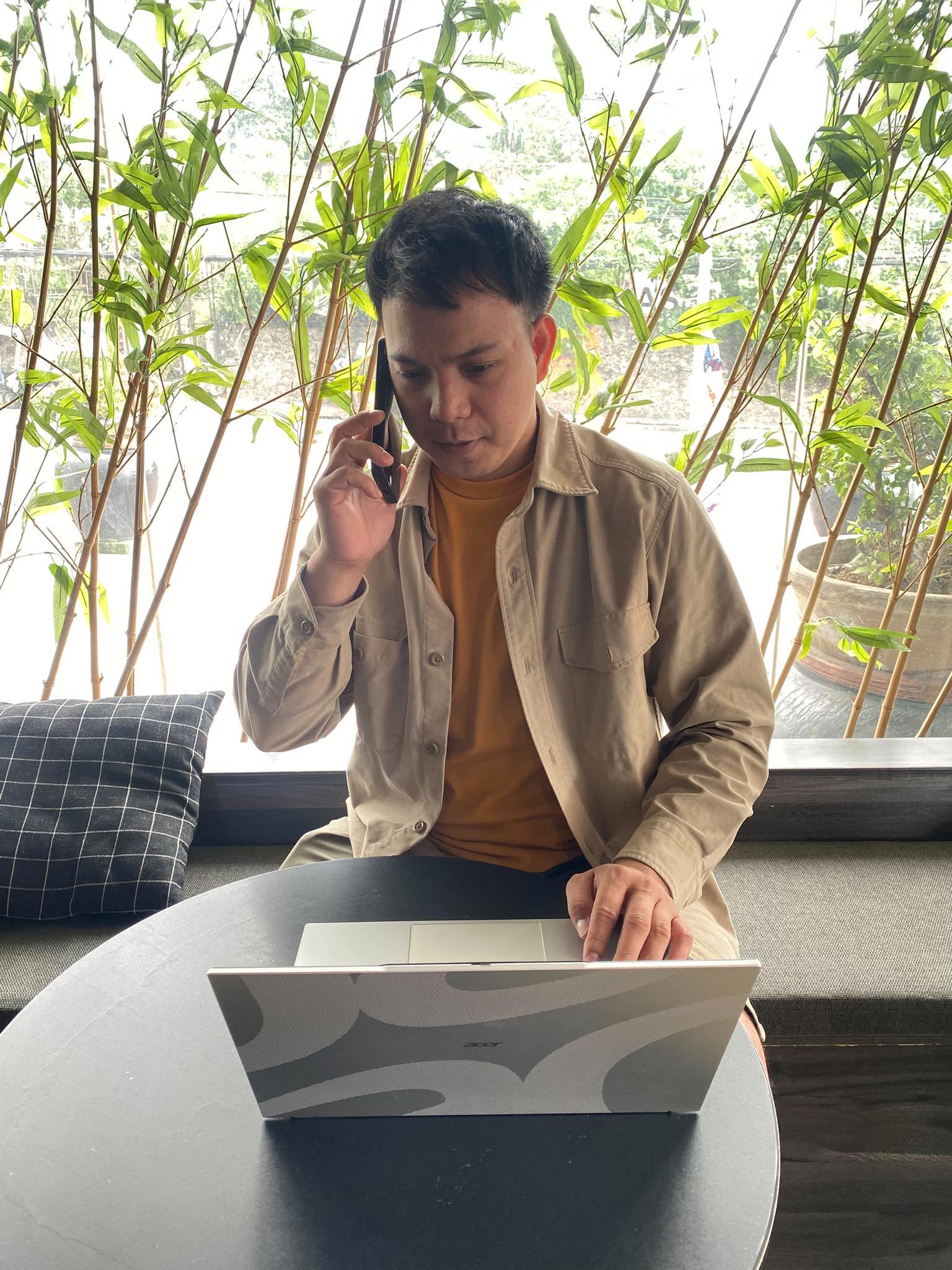 Bobby Mark Abaquita, Corporate Secretary of Artitech, taking a call at his laptop