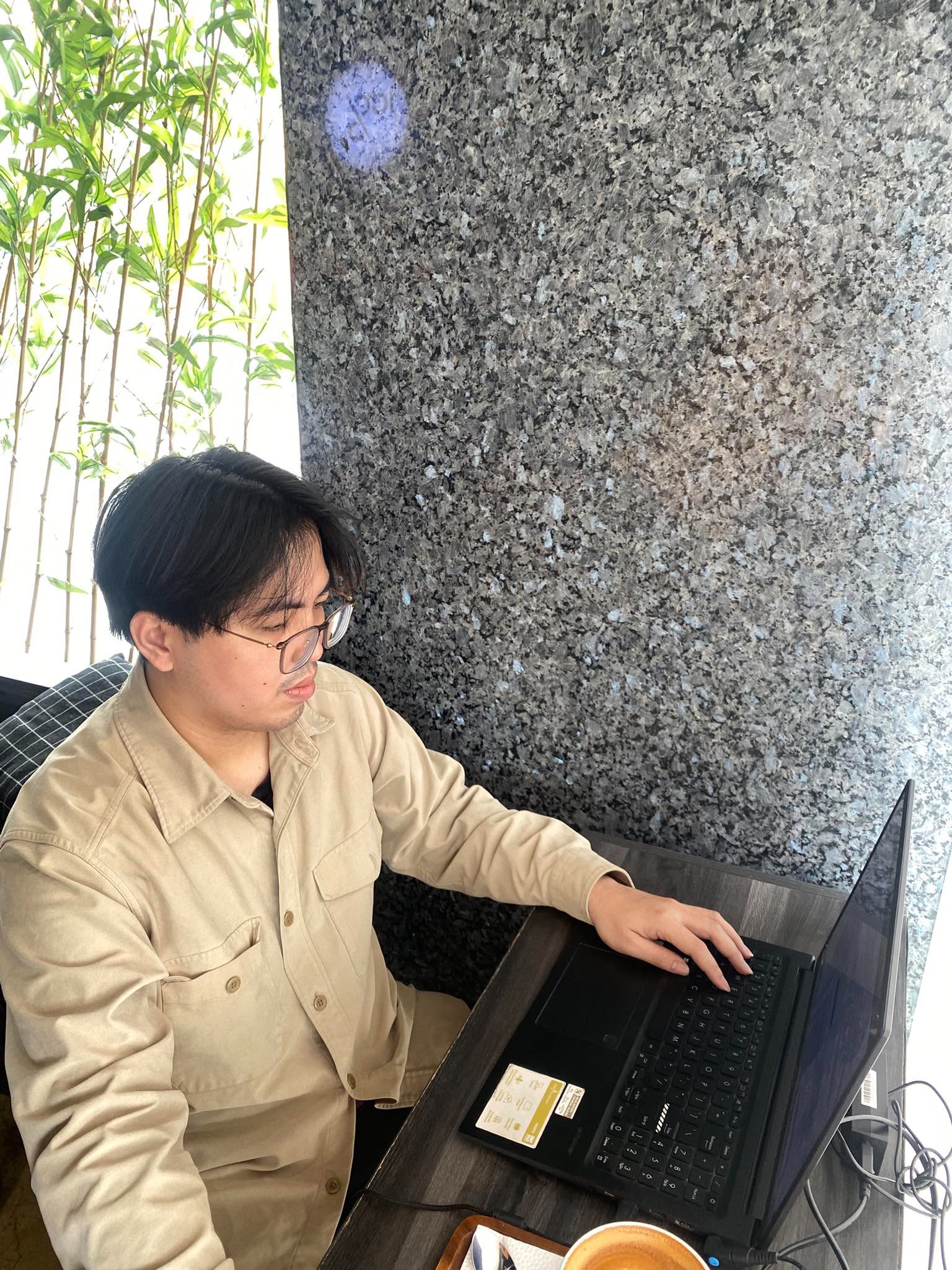 An Artitech developer working at a laptop in the office